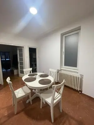a dining room with a table and chairs and a window at New Luxury Strict Center Apartment in Belgrade