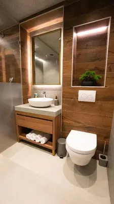 a bathroom with a sink and a toilet and a mirror at Hotel Central in Inđija