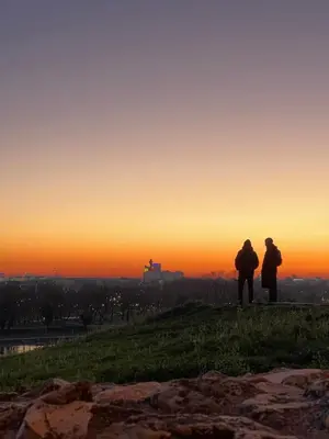 two people standing on a hill watching the sunset at Belgrade center studio apartment in Belgrade
