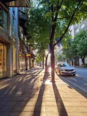 a street with a car parked on the sidewalk at Belgrade center studio apartment in Belgrade