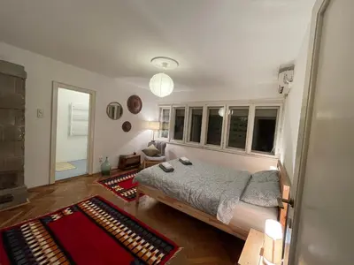 a bedroom with a bed and a large window at Nomad and Home apartment in Belgrade