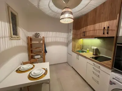 a kitchen with a table with plates on it at Nomad and Home apartment in Belgrade