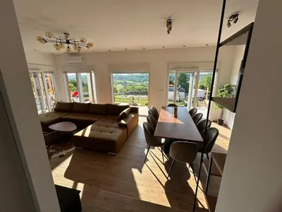 a living room with a couch and a table at Casa Toleni in Ba°evac
