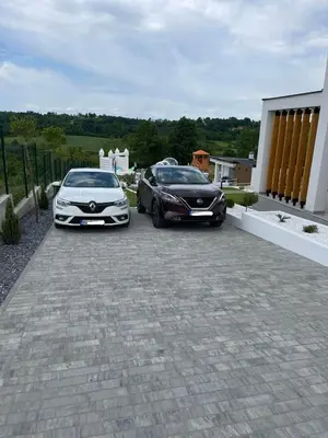 two cars parked next to each other on a driveway at Casa Toleni in Ba°evac