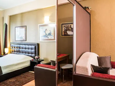 a hotel room with a bed and a mirror at Verdi Apartment in Belgrade