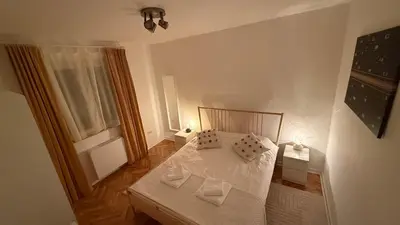 a bedroom with a white bed with two pillows at GardosHouse Apt 2 in Belgrade