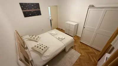 a small bedroom with a white bed with two pillows at GardosHouse Apt 2 in Belgrade