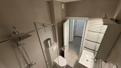 a bathroom with a toilet and a glass shower at GardosHouse Apt 2 in Belgrade