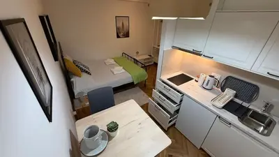 a small room with a small kitchen and a bed at GardosHouse Apt 3 in Belgrade