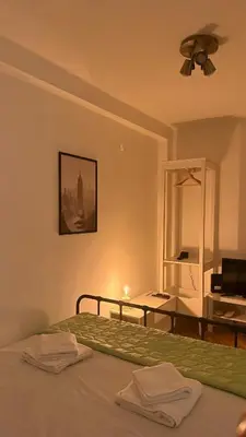 a bedroom with a bed with a desk and a ceiling fan at GardosHouse Apt 3 in Belgrade