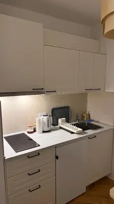 a kitchen with white cabinets and a counter top at GardosHouse Apt 3 in Belgrade