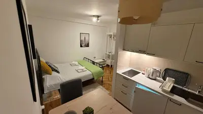 a small room with a bed and a kitchen at GardosHouse Apt 3 in Belgrade