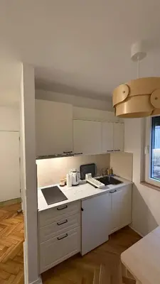 a kitchen with white cabinets and a counter top at GardosHouse Apt 3 in Belgrade