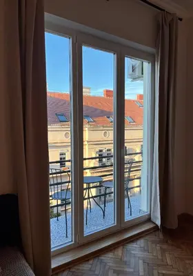 a window with a view of a building at Maison Art Deco Apartment in Belgrade