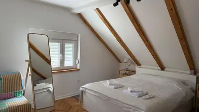 a bedroom with a white bed and a mirror at GardosHouse Apt 4 in Belgrade