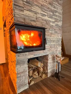a fireplace with a tv on top of it at KosMy dream in Sopot