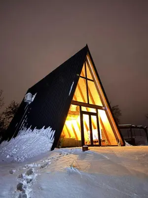 a building with a large glass window in the snow at KosMy dream in Sopot