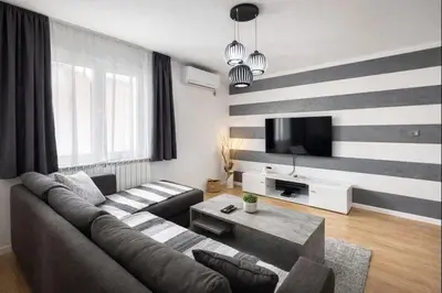a living room with a couch and a tv at Apartman LAV in Belgrade