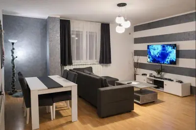 a living room with a couch and a table at Apartman LAV in Belgrade