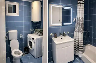 a blue tiled bathroom with a toilet and a sink at Apartman LAV in Belgrade