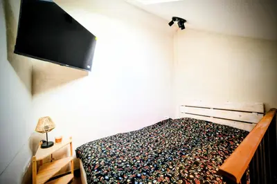 a bedroom with a bed with a tv on the wall at Old Port Riverside Lofts in City Center in Belgrade