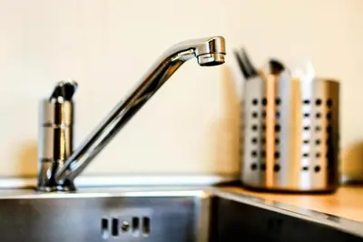 a kitchen sink with a faucet on a counter at Old Port Riverside Lofts in City Center in Belgrade