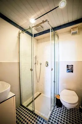 a bathroom with a shower with a toilet and a sink at Old Port Riverside Lofts in City Center in Belgrade