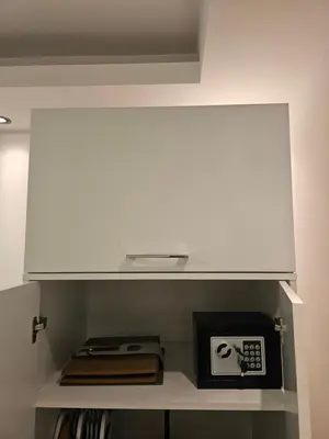 a white cabinet with a microwave on a shelf at Aker in Belgrade