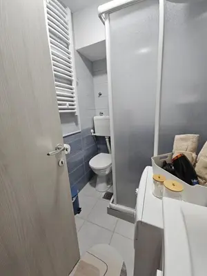 a bathroom with a shower stall and a toilet at Aker in Belgrade