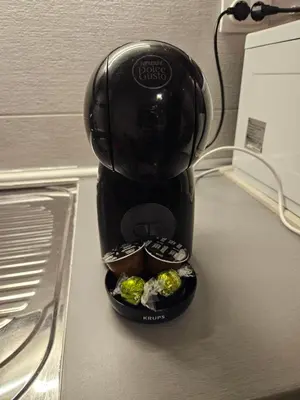 a coffee maker is sitting on a counter with cupcakes at Aker in Belgrade