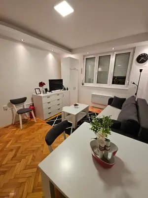 a living room with a couch and a table at Aker in Belgrade