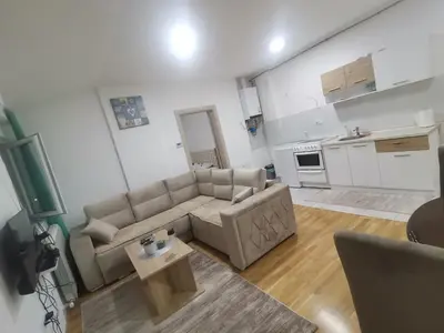 a living room with a couch and a table at Stan na dan Lux Stara Pazova in Stara Pazova