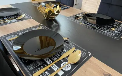 a table with two plates and silverware on it at Dolce Vita in Belgrade