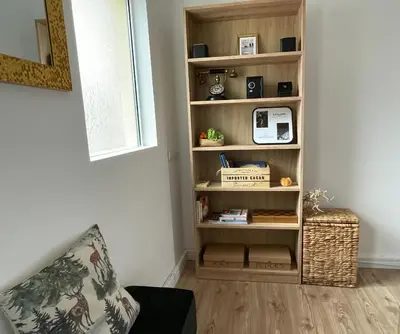 a book shelf in a living room with a couch at Dolce Vita in Belgrade