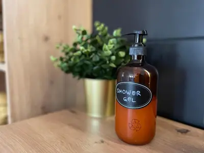 a bottle of sauce sitting on a table with a plant at Dolce Vita in Belgrade