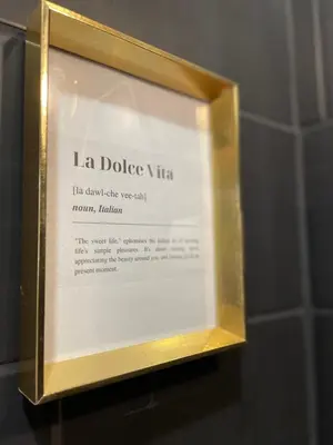 a framed sign on a wall in a bathroom at Dolce Vita in Belgrade