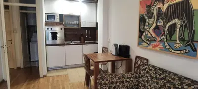 a living room with a table and a kitchen at One Bedroom Apartment Theatre in Belgrade