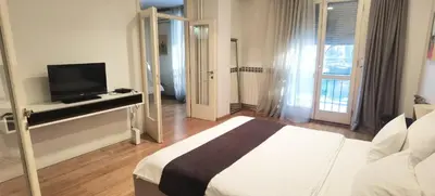 a hotel room with a bed and a television at One Bedroom Apartment Theatre in Belgrade