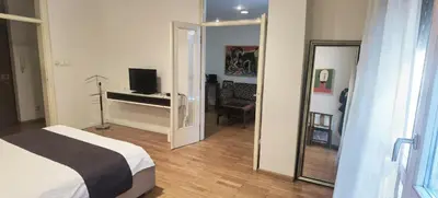 a bedroom with a bed and a desk and a mirror at One Bedroom Apartment Theatre in Belgrade