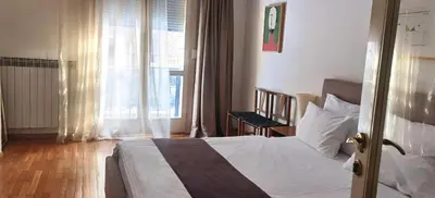 a bedroom with a bed and a large window at One Bedroom Apartment Theatre in Belgrade