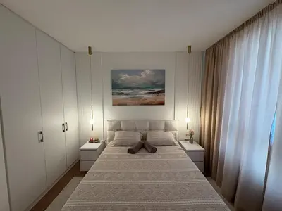 a bedroom with a large bed with two white cabinets at Belgrade Waterfront Quartet 3 in Belgrade