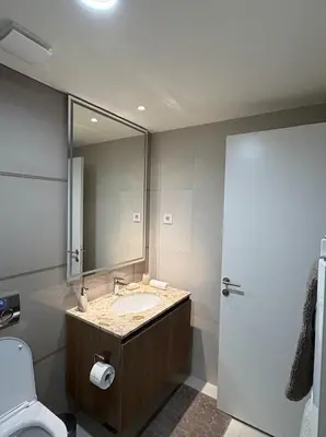 a bathroom with a sink and a mirror and a toilet at Belgrade Waterfront Quartet 3 in Belgrade