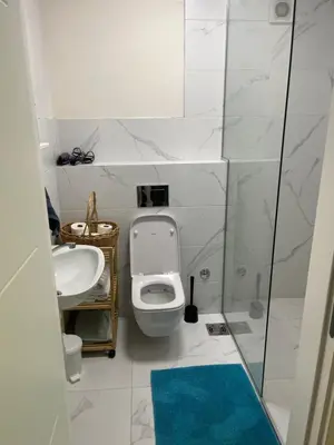 a white bathroom with a toilet and a sink at Mila in Belgrade