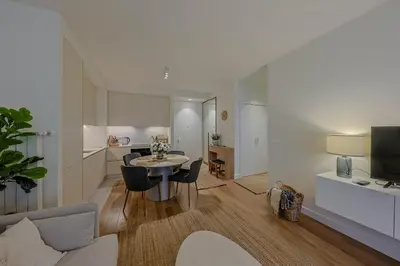 a living room with a table and chairs and a kitchen at S310 with free parking in Belgrade