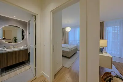 a bathroom with a sink and a bed and a mirror at S310 with free parking in Belgrade