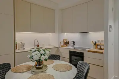 a kitchen with a table with a vase of flowers on it at S310 with free parking in Belgrade
