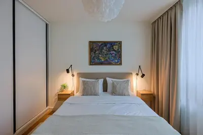 a bedroom with a large white bed with two pillows at S310 with free parking in Belgrade