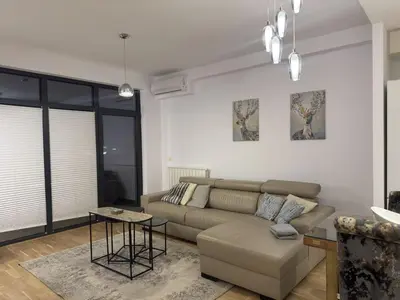 a living room with a couch and a table at Beograd na vodi Belgrade waterfront - 23th floor, great view apartment in Belgrade