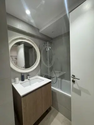 a bathroom with a sink and a mirror and a tub at Beograd na vodi Belgrade waterfront - 23th floor, great view apartment in Belgrade