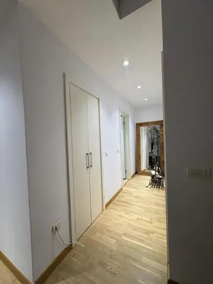 an empty hallway with white walls and a wooden floor at Beograd na vodi Belgrade waterfront - 23th floor, great view apartment in Belgrade